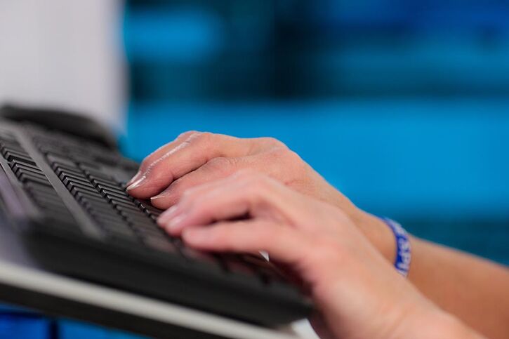 Person typing on keyboard